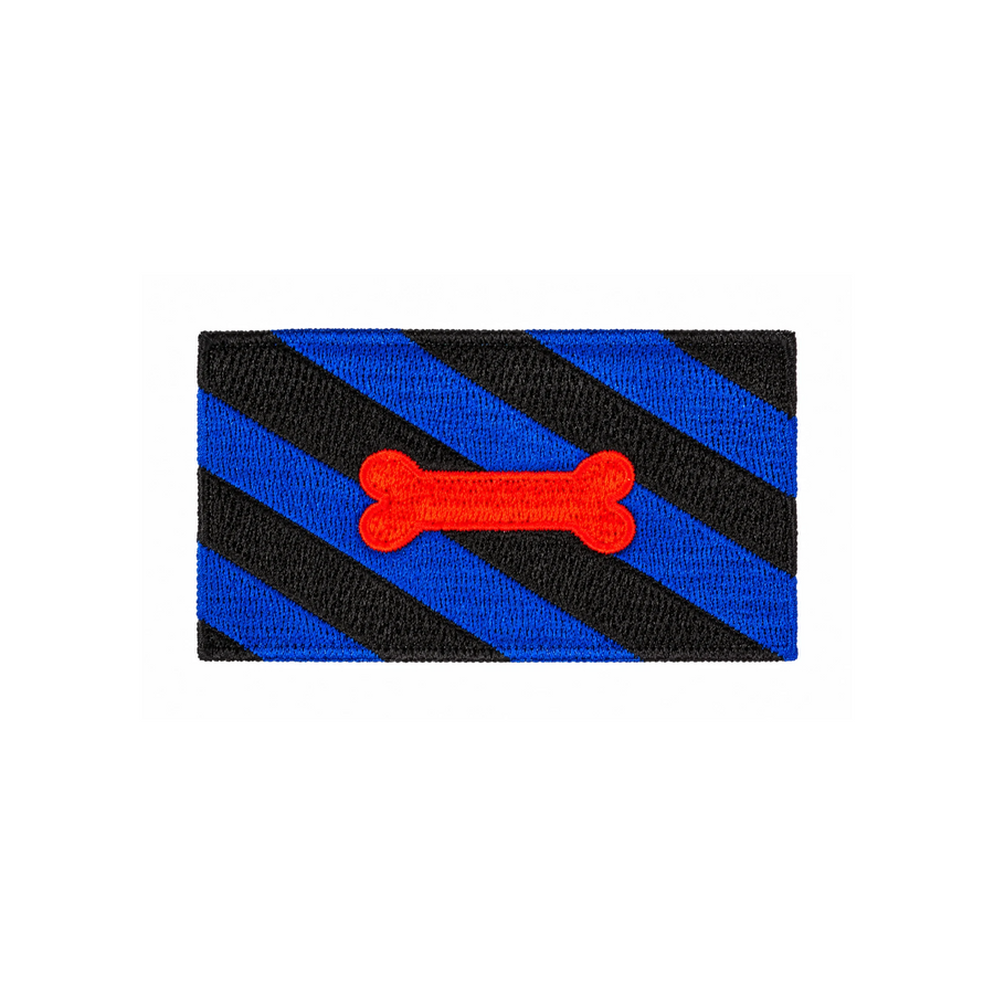 Gestickter Puppy Play Patch, 8 × 5 cm, mit diagonalen blau-schwarzen Streifen und rotem Knochenmotiv. Rechteckiger Aufnäher ohne Klettverschluss auf weissem Hintergrund.