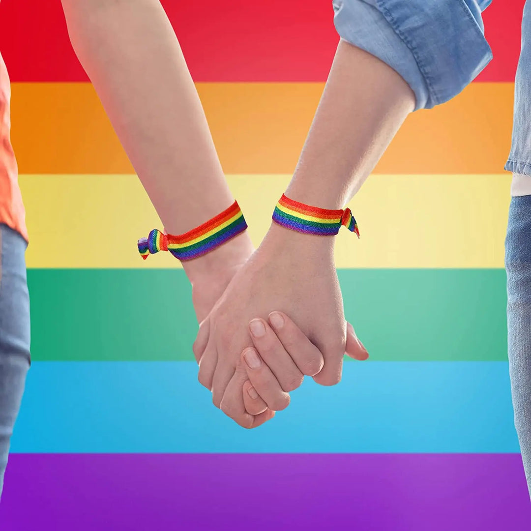 10 elastische Regenbogen-Pride-Armbänder aus Polyester, in zwei Spalten nebeneinander angeordnet auf weißem Hintergrund
