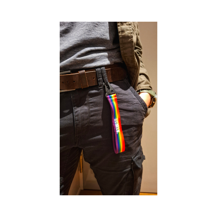 Regenbogen Schluesselanhaenger an der Gürtelschlaufe einer dunklen Cargo Hose getragen