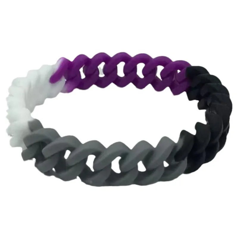 Asexuelles Silikonarmband mit Farbverlauf in Schwarz, Grau, Weiß und Lila in Gliederoptik auf hellem Hintergrund