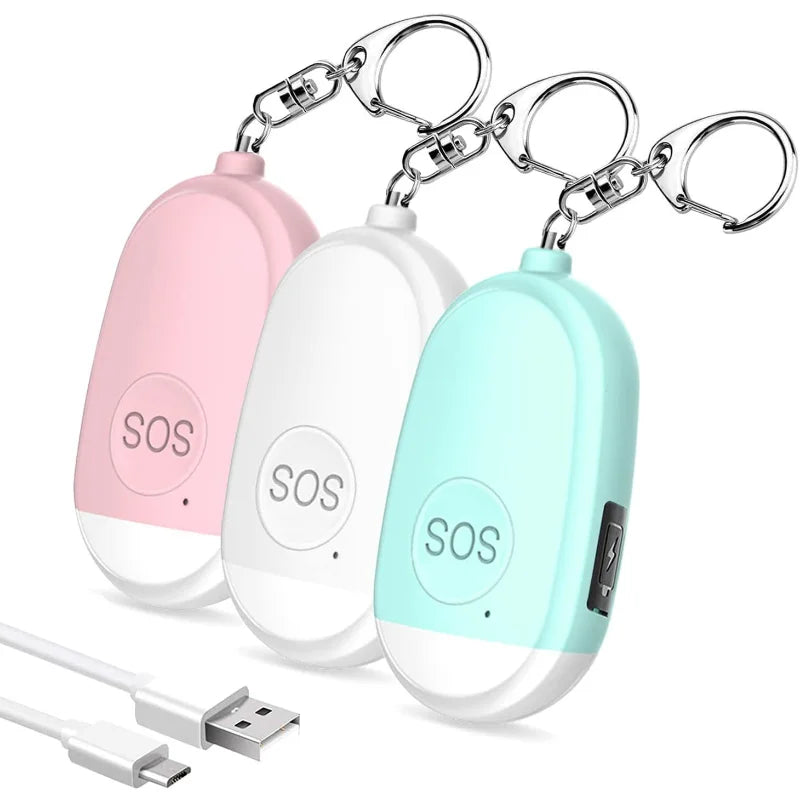 Ein Set aus drei tragbaren SOS-Alarmgeräten in den Farben Rosa, Weiß und Türkis. Jedes Gerät verfügt über einen Schlüsselanhänger und einen USB-Ladeanschluss. Ideal für den persönlichen Schutz und Notfälle.
